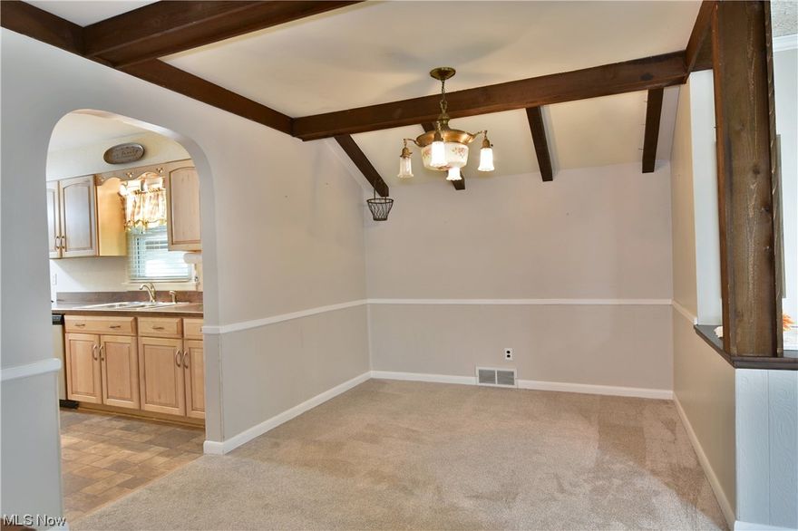 An opportunity like no other with a two floors of sprawling living space that fill this five potential bedroom Champion home! The fantastic looking brick ranch packs plenty of surprises like a stunning, covered rear patio space, an oversized four bay garage with a huge rear workshop and a second detached unit with room for more. Raised stone landscaping wraps around to find the secondary shared driveway and a finished basement walkout from the lower bonus room. Inside, a beautiful, carpeted living room enjoys a large picture window as the central dining space showcases its unique exposed frame design elements and stained wood casing. The ample updated kitchen brings an array of naturally finished cabinetry with stylish countertops that pair with the stainless-steel appliances. The rear hall spans a trio of inviting bedrooms to include the larger master. Built-in cabinets are located outside the main bath with its updated vanity and airy, low step shower. A second kitchenette and half b