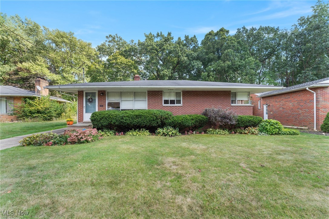 Welcome to 2040 Thurmont Rd – A Charming Brick Ranch in Akron! This well-maintained 3-bedroom, 1.5-bathroom home offers over 1,700 sq. ft. of comfortable living space designed for family enjoyment and everyday convenience. Step inside to a spacious living room filled with natural light from a large picture window—perfect for gatherings and cozy evenings at home. The open layout flows into a dining area and a kitchen that combines style and function with ample cabinet storage, stainless steel appliances, and easy access to the backyard for seamless indoor-outdoor living. Down the hall, you’ll find three inviting bedrooms, including a primary with its own private half bath, plus a full bathroom to serve the household. The finished basement expands your living space with a large recreation room, ideal for a family room or game area, along with a versatile flex room that could be used as a playroom, hobby space, or home office. A laundry area is conveniently located here as well. Outdoors, enjoy a generous backyard that backs right up to Sand Run Metro Park—an incredible bonus for hikers, bikers, and runners who want direct access to nature just steps from home. Whether you’re hosting gatherings, gardening, or simply enjoying a quiet evening surrounded by greenery, this outdoor space offers something for everyone. A detached garage adds parking and extra storage. This move-in ready ranch blends charm, space, and functionality in one desirable package—don’t miss your chance to make it yours!