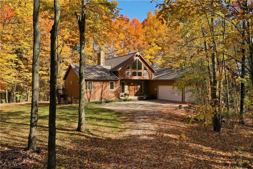 This contemporary home is nestled on 6+ sprawling acres of woods featuring a ravine that adds natural beauty and privacy to the property. The heart of the home is a dramatic vaulted/beamed great room, where a full wall of floor-to-ceiling windows allows for an abundance of natural light to flood the space and offer breathtaking, uninterrupted views of the wooded landscape and ravine. A stone fireplace anchors the room, adding warmth and creating a cozy retreat in all seasons.  The first-floor primary suite offers convenience with a slider to deck, 11' x 6' walk in closet and full bath with soaking tub and walk in shower.  The eat in kitchen offers plenty of cabinet and counter space, pantry and another deck to enjoy the beauty of the setting (all appliances convey with the sale). There is another bedroom, second full bath and mud room completing the first floor.  Imagine using the second floor beamed, vaulted loft as an office, exercise room, guest area or whatever fits your needs.  The lower level is a walk out and would be a perfect additional living space complete with two bedrooms, full bath and recreation room/family room.  The storage/workshop area is a bonus.   Roof replaced - 2022 (50 year shingle).  Three car garage with pull down storage plus there is a shed.  Home warranty is being provided by the seller.
