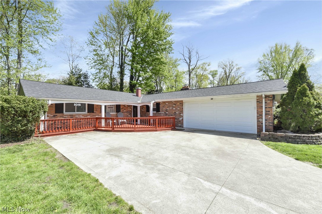 Prepare to be Moved!...into easy one-level living in this neat and tidy ranch tucked away on a quiet, private street in North Olmsted. You will immediately be greeted by the charming front porch with a deck extension. Picture summer evenings relaxing with a good book, listening to the crickets sing, and waving to neighbors as they pass. Step into the spacious living room, brightened by the large picture window and extra-wide slider leading out to the backyard. The vaulted beamed ceiling adds a sense of grandeur to this already spacious room. In the heart of the home you will find an open concept dining room / kitchen with cozy brick fireplace where family and friends will naturally gather around hot food and warm conversation. Door off kitchen provides easy access to the 1.5-car garage with designated laundry space. Just down the hall you will find the master en suite and two additional bedrooms that share the 2nd full bath. All three bedrooms boast large closets for added storage. Enj