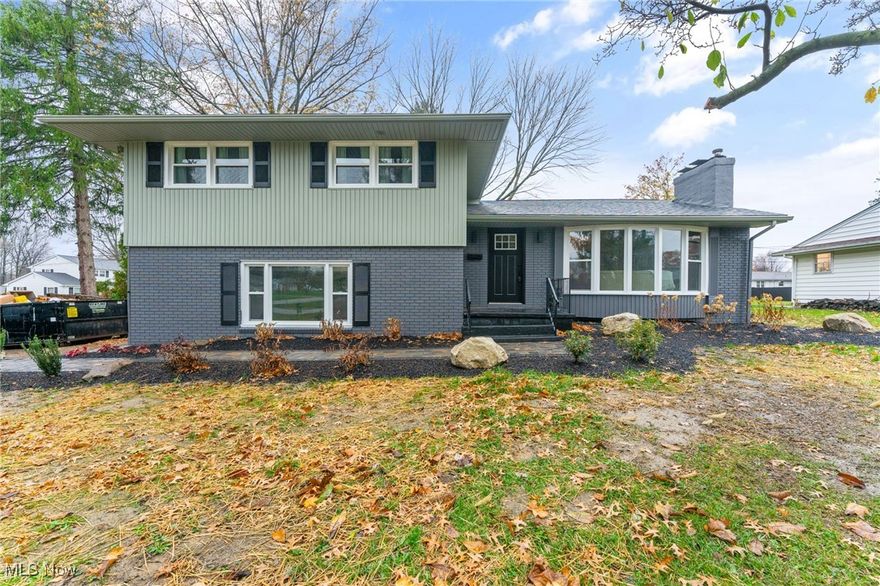 Welcome to 2612 Birchwood Dr, a beautifully remodeled split-level home in the Austintown School District that combines modern updates with timeless style. With 3 bedrooms and 3 bathrooms, this home has undergone a complete transformation, from fresh landscaping to all-new finishes inside and out. The exterior exudes curb appeal with a newly painted brick facade, new vinyl windows, and a dimensional shingled roof. A stone walkway leads you to the front door or take the back entry with boulder rocks that lead you to the covered back patio, creating a serene outdoor setting perfect for relaxation or entertaining. Step inside to the spacious foyer, which flows seamlessly into a large living room featuring a black brick fireplace and brand-new carpeting. The newly remodeled eat-in kitchen is a chef’s delight, boasting solid wood cabinets, hi-definition Formica countertops, a subway tile backsplash, stainless steel appliances, and a designated coffee station. Vinyl plank flooring adds style and durability, extending into an adjoining dining area. A versatile bonus room offers additional living space, ideal for a media room, home office, or playroom, with easy access to the back patio and an attached 2-car garage. Upstairs, the master suite awaits with double closets and a private bathroom featuring a walk-in tiled shower. Two additional bedrooms provide ample closet space and share a well-appointed full bathroom. The basement has been waterproofed and includes a laundry area, half bath, storage, and new mechanicals: HVAC, 100-amp electrical panel, and a hot water tank. With fresh paint, updated lighting fixtures, and all-new electrical throughout, this high-quality, renovated home offers comfort and convenience in a fantastic location.  Don’t miss the chance to own this move-in-ready home, where every detail has been carefully considered for modern living.