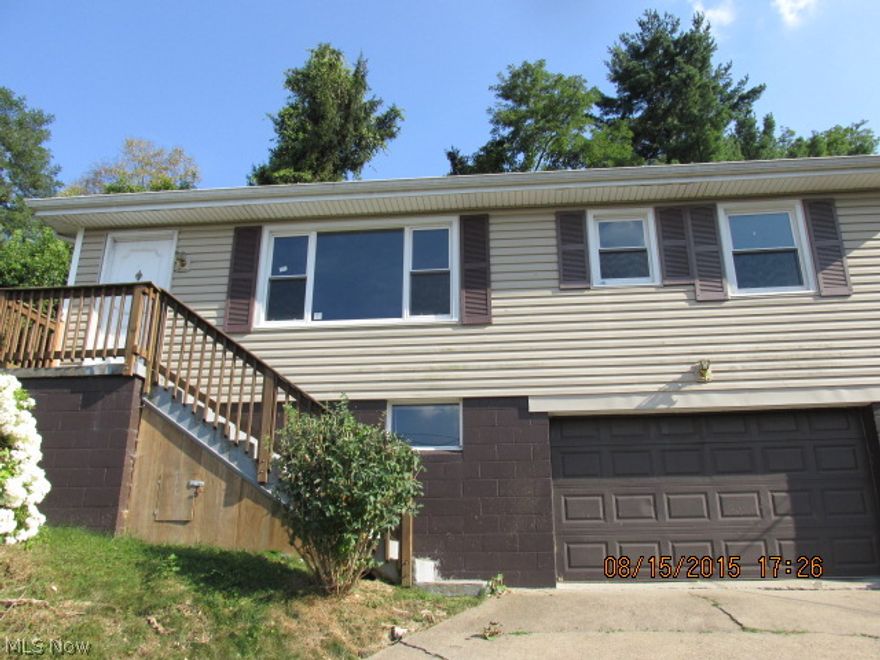 1 Story 2 bedroom 1 bath home with 1 car garage,  rear deck and  outdoor storage building.