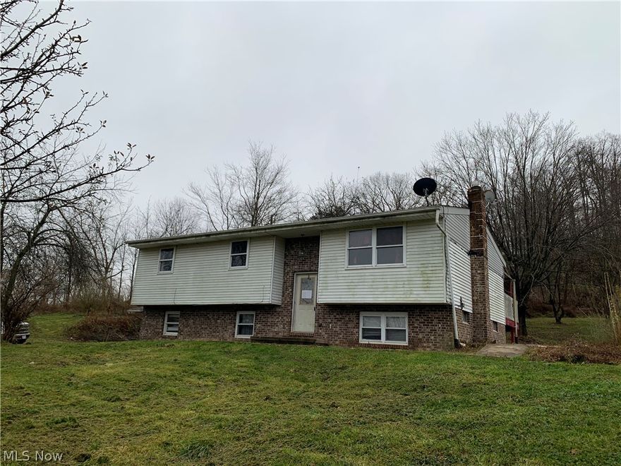 Great investment opportunity on 3.48 acres just outside of town. This property is a bi-level home with 3-4 bedrooms, 2 1/2 baths and a full partially finished walk out basement. There is a newer furnace with a heat pump that was installed in 2014. There is also a detached building that was once set up as an in-law suite with a 1 car garage. There are 3 parcels total that transfer with a total of 3.48 acres with a nice recreational pond. The mineral rights are not included. There is a shared driveway to the property. This property sells as-is only to cash buyers. The owner does not make any disclosures to the condition of this property. The owner will not make any repairs needed from the point of sale inspection. The list price is based off of the current as-is value. Realtor owned. Possible owner financing available.