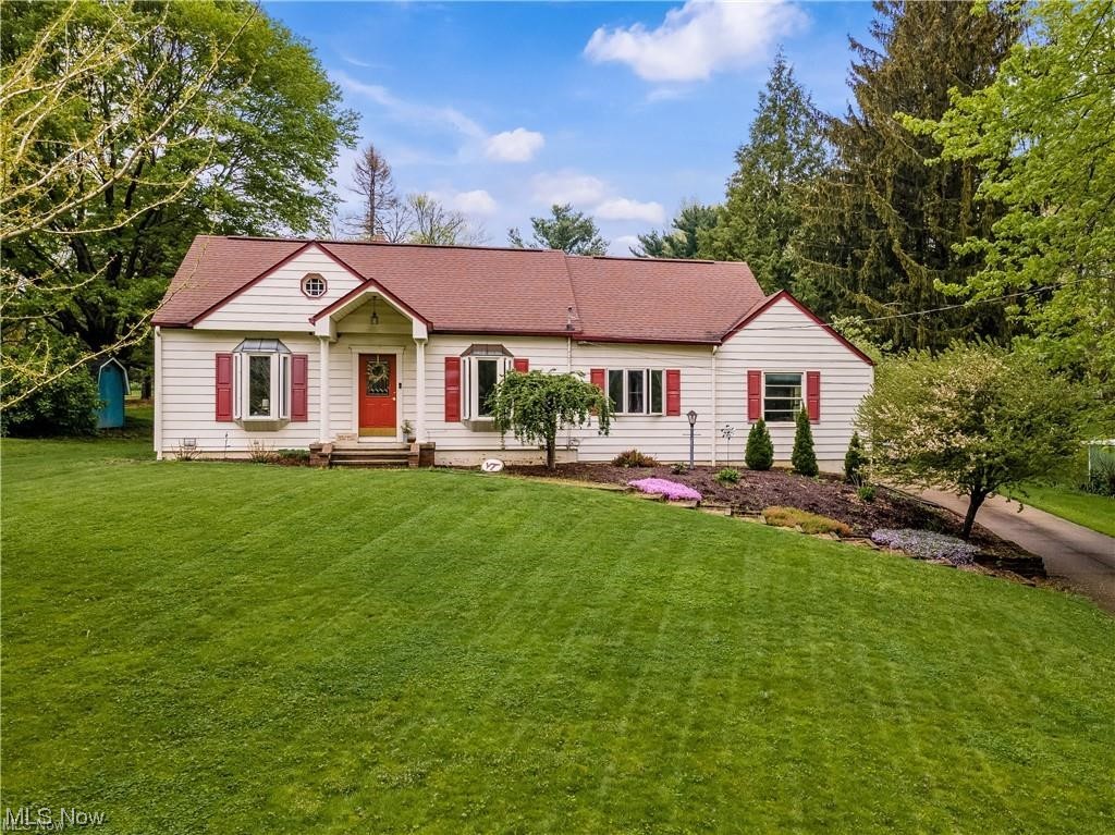 On a quiet horseshoe-shaped road in one of America's Safest Cities, sits a unique Cape Cod unlike any other on the block. Upon entering the south-facing front living room, the original hardwood floor leads the way to the sunken family room that sits perpendicular to both the front room and the eat-in kitchen with its updated countertops and cabinetry, newer plumbing and lighting fixtures, and stainless steel appliances. With the addition of the family room, the option exists to designate the living room as a formal dining area. At the rear northeast corner, just beyond where the kitchen and family room intersect are doors leading to an enclosed four seasons room and the attached oversized garage. Upstairs is a dedicated 31x10 owners suite with vaulted ceilings, wall-to-wall wood floors, a built-in dresser and linen closet, and a built-in bookshelf and walk-in closet. If the massive 2nd-floor bedroom isn't enough, there is an 8x11 en suite with his and her vanities, a walk-in shower, and more of those gorgeous wood floors. This modified Cape Cod can only properly be described as a Cape Mod. And there's more... The distribution panel was replaced with a 200 amp service in 2021. In May of 2022, ceiling fans were installed in every first-floor room, and whole-house foam and blown-in attic insulation were added. Finally, the Well Rite extra large pressure tank was installed in 2022 and in February 2024 a full septic replacement was completed. After replacing the entire west foundation wall in 2021, waterproofing inside and out, and replacing the downspouts and drainage, half of the basement was finished into a 30x11 rec room in 2023, and exterior and interior painting proved the final touches to the home by our current homeowner. The over half-acre lot is conducive to productive family activities and entertaining alike. This home is clean, updated, and structurally sound and Manchester Local Schools and the City of New Franklin are highly regarded. Come see for yourself