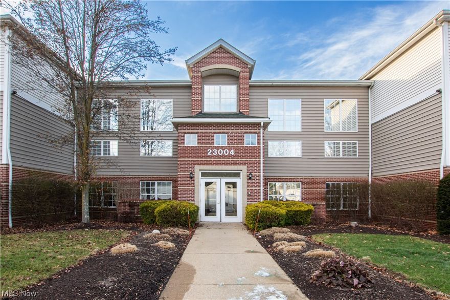 Welcome home to this updated single-story condominium with an elevator that is situated in a tranquil and secluded location, featuring a spacious open floor plan. The kitchen is equipped with a breakfast bar, stainless steel appliances, and newer luxury vinyl tile flooring. The living and dining areas have neutral carpeting, and the living room boasts a gas fireplace with sliding doors leading to a private balcony offering serene views. The primary bedroom features newer carpeting, a large closet, and a private entrance to the bathroom. The full bathroom is adorned with the same luxury vinyl tile flooring and includes a shower/tub combo. The office/den is well-lit with natural light. The laundry room, complete with a washer and dryer, is conveniently located adjacent to the kitchen. A one-car garage is included. Additionally, there is a storage unit on the second floor. A new hot water heater has recentely been installed in 2022. Don't miss your chance at this beautiful home! Schedule your tour today!