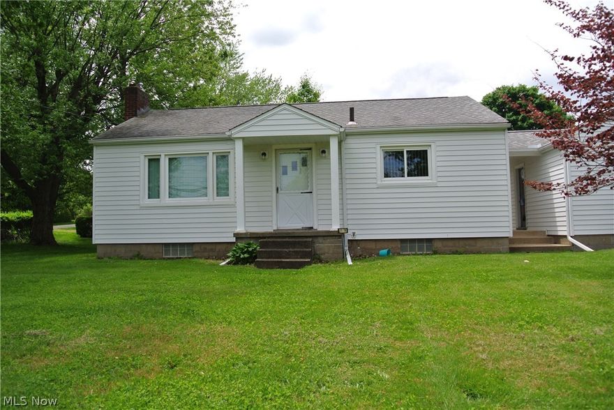 Akron 2 bedroom 1 bath ranch on a corner lot with a one car garage attached to the home with a breezeway, and an additional 2 car detached garage with heat and A/C.  Fireplace in basement.  Includes kitchen appliances and washer & dryer.