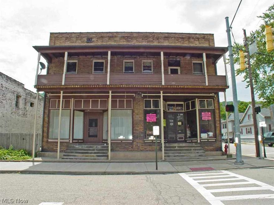 Step  into the past with this historic downtown brick building.  The store front features original tin ceilings and reclaimed barn wood floors.  he building also houses 5 apartments with parking for 6.  Great income potential. .