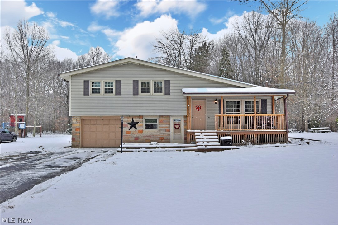Hurry now! This fabulous three-bedroom, split level home is just hitting the market and is sure to go quickly! With beautiful, well-kept rooms and a charming exterior; this dead end drive residence isn’t one to sleep on. Curb appeal is huge here, with a partial brick façade and a new welcoming covered front porch. A blacktop drive leads you closer into the land locked property, full of scenic backyard views. Inside the residence, high quality and comfort are immediately apparent as you make your way through the foyer and coatroom and into the spacious living room. Here, natural light pours into the window lined room, with a pair of oversized picture windows looking out towards the front yard. Tall ceilings arch upwards in the direction of a short wooden staircase leading to the second-floor bedrooms. A decadent full bath marks the first stop down the hall, with large wood trimmed vanity and tasteful tile work on the floor and surround. Each bedroom offers hardwood flooring and natural