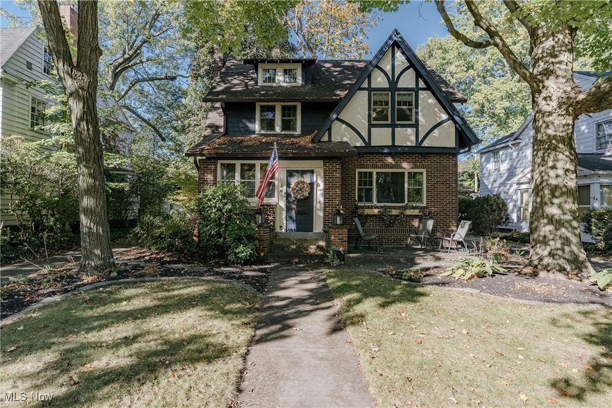 Welcome to 68 Kenilworth Dr – A Beautiful Tudor-Style Colonial Full of Character and Comfort!
Nestled on a quiet, tree-lined street in Akron’s desirable Wallhaven neighborhood, this 4-bedroom, 2.5-bath home blends timeless Tudor charm with thoughtful updates—perfect for families seeking warmth, space, and personality. You’re first welcomed by a delightful enclosed front porch, beautifully accented in calming blue tones with large windows and a ceiling fan—an ideal spot for morning coffee or relaxing evenings. Step inside to a spacious living room featuring hardwood floors, a cozy fireplace framed by an elegant arched nook. The formal dining room continues the character with two built-in corner cabinets, a large picture window, and modern lighting, creating a bright and inviting space for family meals and entertaining. The kitchen combines charm and practicality with stainless steel appliances, hardwood flooring, and a subway tile backsplash. A convenient half bath is located near the back door to complete the main level. Upstairs, you’ll find three spacious bedrooms, all with hardwood flooring and generous closet space, along with an updated full bathroom designed for everyday comfort. The finished third floor/attic adds a versatile bonus space—serving as a fourth bedroom with its own full bath featuring a soaking tub for ultimate relaxation. The lower level offers even more possibilities, with a recreation area, laundry and utility room, storage, and workshop space. Outside, enjoy a fully fenced backyard—perfect for play, pets, or peaceful evenings—complete with a patio for gatherings and a detached two-car garage. This home beautifully balances classic design and modern comfort. Move right in and make lasting memories at 68 Kenilworth Dr—a true Akron gem filled with warmth and charm!