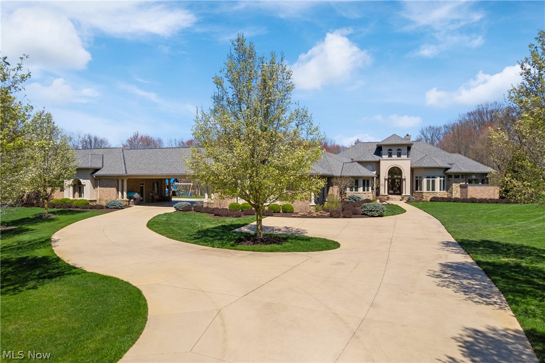 Exquisite custom built 6400 sq. ft. ranch on 14.28 acre private gated estate located in North Canton will take your breath away. Great floor plan, soaring ceilings and custom wood accents, built in cabinetry and amenities. Absolutely beautiful inside with views of inground pool, luscious grounds, pond and woods. Attached garage fits 5 cars and other side of portico houses 5 more. Both are heated, water hook-ups and a full bath, office, and Kitchenette. There are 2 luxurious Master Suites with adjacent offices and unbelievable bathrooms with tiled walk-in showers. You will love the openness from the custom Kitchen with commercial high end appliances into the Dinette and Great Room. All the bells and whistles you could desire. 6-1/2 Baths, 3 fireplaces, enormous covered porch with outdoor Kitchen and a Pool Bathroom overlooking inground salt water pool. New liner being installed in June and a whole house generator.