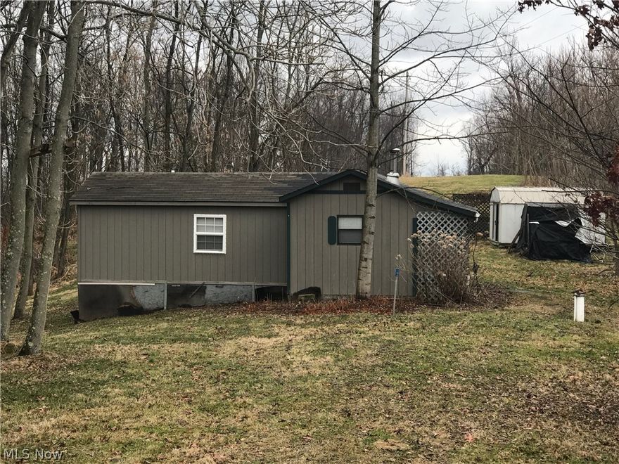 Have your own tiny house on 7 plus acres.  Very private and wooded.  For someone looking for acreage to build this has your septic and well and would be great for a log home. Some furnishings included and ready for hunting season or just a get-a-way.  Close to Salt Fork State Park and Seneca Lake.  Just a short distance to I70 so convent from most any where. Come and enjoy nature. Restrictions are in office.