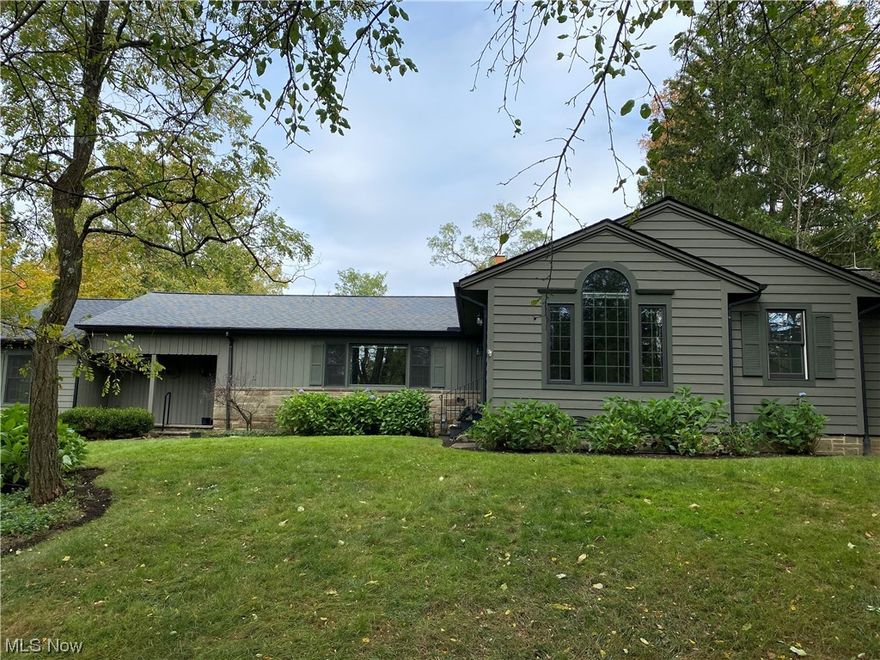 A private oasis in Chagrin Falls with loads of upgrades.  Beautifully updated 4 bedroom/3 full bath ranch with private pond, located near the top of Grove Hill it's an easy walk to downtown Chagrin Falls.  The main floor features an updated white eat-in kitchen with black Corian countertops and beautiful dark solid wood floors throughout the main floor.  Sliding glass doors off the kitchen/breakfast room leads to a large multi-level deck perfect entertaining or for a quite retreat.  Adjacent to the eat-in kitchen is large family room with built in bookshelves and doors leading to deck, and a palladium window which overlooks the pond and yard.  There is also a formal dining room  with doors to upper deck and living room with a gas fireplace. Two bedrooms share a hall bath.  The master suite is large with doors that open to the front yard. It also has a lovely master bath with jacuzzi soaking tub.  The lower walkout is partially finished with a cozy wood paneled bedroom/family room with a wall of built-in bookshelves, another gas fireplace, and walk-out access to the lower patio.  Adjacent to a full bath is a  workout room with a padded aerobic floor and stocked with numerous pieces of exercise equipment (Equipment can stay if desired). The laundry and utility rooms are also on the lower level.  A Generac whole house automatic generator is installed so you are never without power.  And don’t miss the audio speakers throughout the home.  Home warranty included.