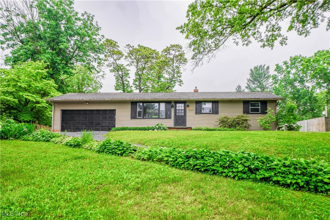 Enjoy the convenience of ranch living in this beautifully updated 4 bedroom home in Jackson! Recent updates include new windows, furnace, A/C, hot water tank, shutters, flooring, lighting, and more. The transformed interior offers an open flow between the living room and the bright, modern kitchen featuring quartz counters, a tile backsplash, and black appliances. A sliding door off the dining area leads to the patio, perfect for outdoor meals or relaxing evenings. Down the hall, you'll find three comfortable bedrooms and two full baths, including the primary suite with its own private bath and a corner shower tucked behind a sliding barn door. The updated main bath features a tub with a decorative tile surround. The lower level adds even more living space with a fourth bedroom and a rec room with a brick accent wall, new carpet, and an open joist ceiling. Outside, nearly half an acre gives you room to spread out, with a large shed for storage and extra parking next to the two car heated garage. Hurry to see this one!