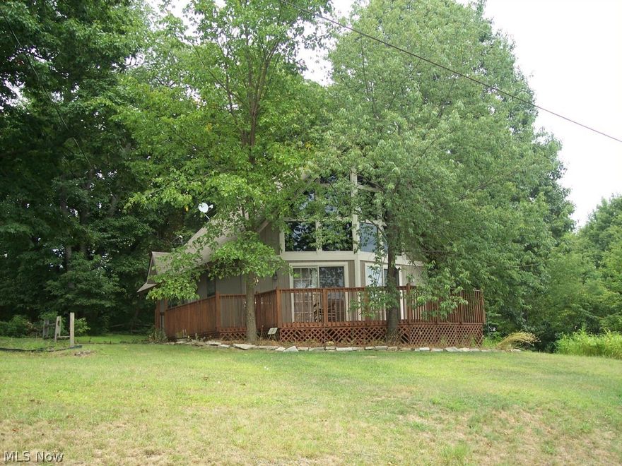 Beautifully remodeled A-Frame with Lake View and 2 Car Garage.  Home Features Include: Updated Oak Kitchen with appliances with Ceramic Tile Floor and Breakfast Area, Large Open Living Room with View of Lake, Loft could be a Huge Master Bedroom or family room/game room.  Updated Bathroom, and a Front Deck with Lake View. Updates Include: Newer Flooring, Newer Light Fixtures, New Roof – 2008.  Home offers 4 very efficient individual heat and A/C units that are heat pumps.  Nice 2 Car Garage offers concrete floors, storage loft, electric, and door opener.  Enjoy the view of the lake from the deck and living room. Move-in condition home. A must see.