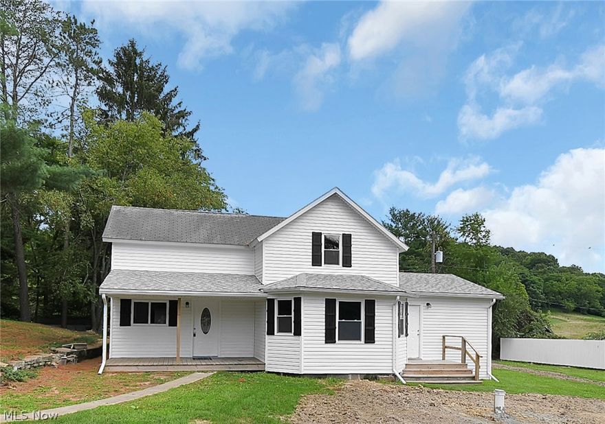 Tucked back on a quiet road in Tri-Valley schools you will find this 1860 farmhouse renovated down to the studs, rebuilt, with a new addition! Secluded and private - but just 2.5 miles/5 minutes to the SR 586/Route 16 interchange. Too many improvements to list them all here, please see the Improvements List attached. On the main floor is the new eat-in kitchen, pantry, half bath/laundry, living room, and primary suite. Upstairs there are two large bedrooms, a full bath, and landing area that could be used as an office.  Outside you'll find a 4 car garage, 1 car garage, storage shed over the spring, pond, white picket fence to provide additional privacy, and an open/one room log cabin structure that would be a great project/future party space by the pond. A truly unique property!
