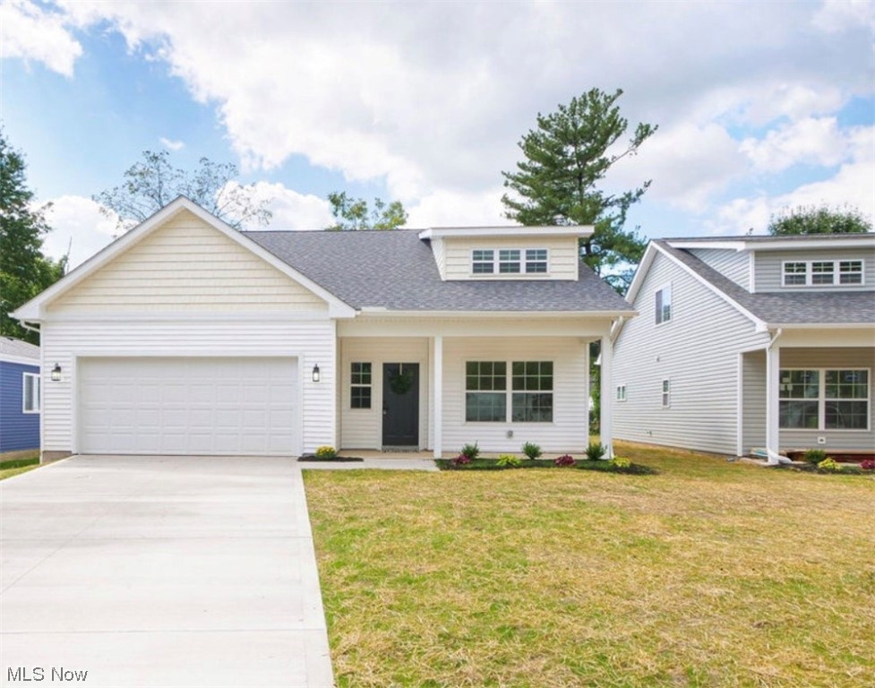 15 YEAR TAX ABATEMENT! This move in ready new construction home in the city of Berea is what you have been looking for. There is a beautiful, well lit front porch to welcome you and your guests inside. A two story foyer waits to greet you upon entering. You will love the wide plank wood floors spanning throughout the main level. Whether you’re hosting gatherings, watching the children play outdoors or simply enjoying a quiet evening in, it’ll be a cinch in the open concept living, dining rooms and kitchen. Filled with tons of natural light, this zone allows you to cozy up to the gas fireplace, or demonstrate your inner chef in the gourmet kitchen with large center island, gorgeous quartz countertops and upgraded stainless steel appliances. The first floor master, with en-suite, makes for an easy retreat. Outfitted with a double sink vanity, extra large tiled shower and spacious closet, you’ll quickly make it your haven. Plush carpeting leads you to the second level with three additiona