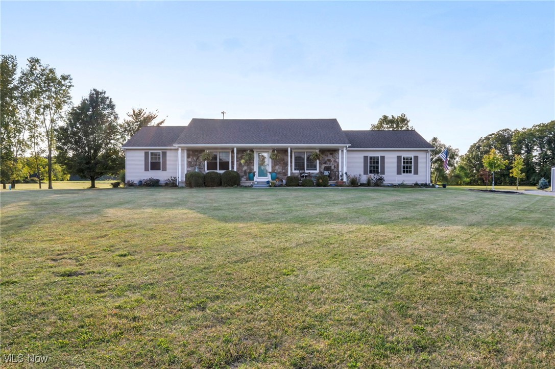 Welcome to 25600 McMillan Rd in Wellington, OH—located in the Black River Local School District, minutes away from Findley State Park and the historic Wellington Town Center! Nestled on over 3 acres at the end of a quiet country road, this thoughtfully updated ranch blends open living spaces, natural light, and modern comfort. With more than 3,400 square feet of finished living space, there is plenty of room here to spread out, relax, and entertain. The open floor plan flows seamlessly from the foyer (with custom built-in cubbies) into the eat-in kitchen, complete with Corian countertops, a center island, GE appliances, and a spacious dining area. Just steps away, the spectacular 4-season sunroom shines with vaulted ceilings, walls of windows, and a brand-new electric fireplace for warmth & charm, bright inviting spots to enjoy morning coffee, an enjoyable book, or gatherings with friends. Three generous bedrooms, including a private primary suite, provide comfortable retreats, while first-floor laundry adds convenience to everyday living. The finished lower level nearly doubles your space, featuring a wet bar, half bath, media room, and craft room—ideal for hobbies, game nights, or guests. Outdoors, enjoy a fabulous country view in your own backyard retreat with a patio, wood deck surrounding the above-ground pool, and a fenced area perfect for pets. Whether you are entertaining, playing, or just relaxing in the fresh country air, this home has the space to enjoy it all. An attached two-car garage, storage shed. central air, and thoughtful updates complete the package. This well-maintained, reflects true pride in ownership inside and out. If you have been searching for a property that combines openness, functionality, and outdoor living in a peaceful setting—this is it. Ask for a list of the updates and features of this home over and above what is in the listing. of Schedule your private showing today and see all that this beautiful Wellington home has to offer!