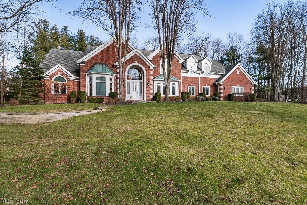 Custom Built by Reggie Home Construction. This all brick majestic home is nestled in the private community of Village Trails in Gates Mills. Welcome to your grand foyer with 18' soaring ceiling, marble floor, curved stair case and crystal chandelier. Formal living and dining rooms on either side of foyer. Gorgeous great room features two custom built lighted wall units that surround the custom fireplace. Gorgeous two story great room with incredible coffered ceiling, and wall of windows! Complimenting the great room is a coffee bar. Special custom features of the kitchen are large center island/breakfast bar, oversized sub-zero refrigerators\, Bosch double ovens, Dacor cooktop and more than ample cabinetry! One of two laundry rooms is on the first floor. First floor Primary Suite has large bedroom, double walk in closets, glamour bath with walk in shower & jacuzzi tub. Private office is off of primary suite. Second bedroom has ensuite bathroom. Follow the curved staircase to 2nd floo