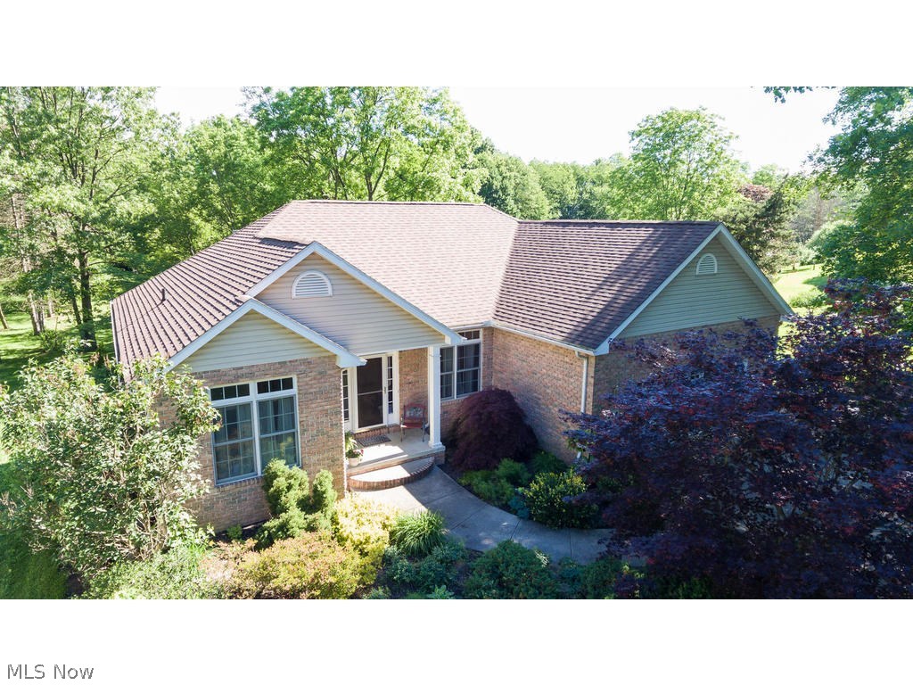 Stunning Munroe Falls Open-Concept Custom Built Modern Ranch with 4 Bedrooms and 3 Full Baths on nearly a full acre of land! Unheard of! Now add a Tiered- Seating 7-point surround sound Home Theater, Finished Walk-Out Basement that can be additional recreation room, but is currently set up as a large office with room to spare! Great Room boasts light from front to back of the home and view into the trees of the park-like back yard. Spa-like Master Suite with whirl-pool tub and double walk-in closets! Brand New Stainless Steel Appliances June 2017! Too many extras to list them all, but we'll try: Outbuilding at back of property, Upper deck, lower patio and flagstone covered patio, Access to Bike Trail at the rear of the property, Central Vac, oversized doorways in what could be an In-Law Suite, Professionally Landscaped yard, and extra-long driveway with additional parking and two turn-arounds, and additional huge unfinished storage in the basement on top of the already abundant finishe