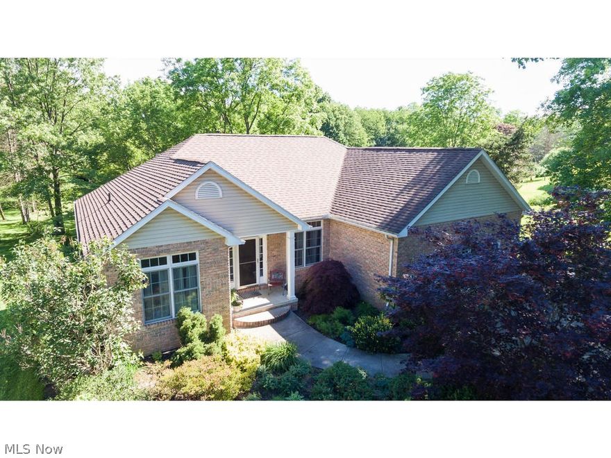 Stunning Munroe Falls Open-Concept Custom Built Modern Ranch with 4 Bedrooms and 3 Full Baths on nearly a full acre of land! Unheard of! Now add a Tiered- Seating 7-point surround sound Home Theater, Finished Walk-Out Basement that can be additional recreation room, but is currently set up as a large office with room to spare! Great Room boasts light from front to back of the home and view into the trees of the park-like back yard. Spa-like Master Suite with whirl-pool tub and double walk-in closets! Brand New Stainless Steel Appliances June 2017! Too many extras to list them all, but we'll try: Outbuilding at back of property, Upper deck, lower patio and flagstone covered patio, Access to Bike Trail at the rear of the property, Central Vac, oversized doorways in what could be an In-Law Suite, Professionally Landscaped yard, and extra-long driveway with additional parking and two turn-arounds, and additional huge unfinished storage in the basement on top of the already abundant finishe