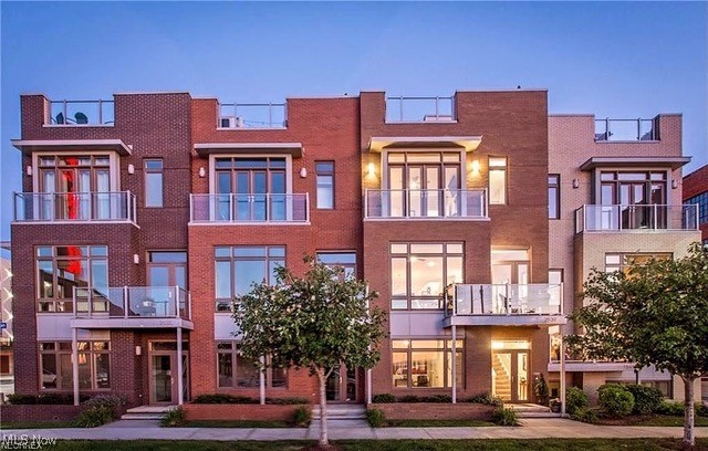 Introducing an exquisite addition to Battery Park's prestigious Edgewater Luxury Collection: a three-bedroom, two-and-a-half-bath townhome that redefines urban living. Nestled amidst breathtaking lake and city vistas, this exceptional residence offers unparalleled convenience and sophistication. Located mere steps from the Edgewater Beach access tunnel and esteemed locales such as Terrestrial Brewing Company, Gordon Square, and 78th Street Studios, this townhome promises an enriching lifestyle filled with cultural and recreational delights. A unique feature of this townhome is its versatile first-floor bedroom, complete with a full bath, ideal for a home office or guest suite. The main living level bathes in natural light and showcases sweeping views of Lake Erie and the Edgewater State Park Beach house. Perfect for hosting, the expansive center island, adorned with high-end quartz counters, complements the plank hardwood flooring and upgraded kitchen cabinetry and appliances. Ascending to the third floor reveals another full bath and a generously-sized alternate bedroom with a spacious walk-in closet. The owner's retreat on the fourth floor is a sanctuary unto itself, boasting an ensuite bath with dual vanities and a fully tiled, wall-to-wall shower. Crowning this unparalleled residence is the fourth-floor oasis featuring a wet bar and rooftop deck—a perfect venue for entertaining guests while relishing 360-degree views of the cityscape and lake. Don't miss your chance to elevate your lifestyle—schedule your private showing today.