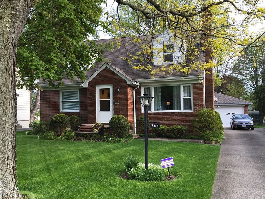 Maintenance free 4 bedroom, 2 1/2 bath BRICK Cape located in pride-in-ownership neighborhood! There is much more to this home than one sees from the street: 3 car garage with wood burner, covered patio, and nicely sized fenced-in yard behind garage. Inside, large living room with gas fireplace. Roomy kitchen with oak cabinetry, dining area, fridge, & newer range. Two first floor bedrooms and a full bath complete the first floor. Upstairs are two additional spacious bedrooms and a half bath. The basement offers an enormous rec room, laundry room, canning & storage closets, full bath, bonus 2nd kitchen, updated electric, and newer high efficiency furnace. Whole house fan and central air. Interior painted in modern, neutral colors. Beautiful hardwood flooring first floor bedrooms. Brand new frieze carpeting in living room, up staircase, and in both upper level bedrooms. Attractive wood moldings, multiple built-ins, cove ceiling, and arched doorways add the charm of this beautiful home. So