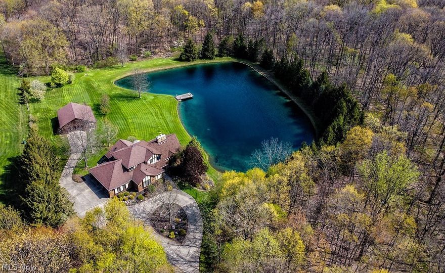 This gated estate sits several hundred feet off the road, and is accessed by a long, scenic, private concrete driveway that opens to a stunning home with a circular driveway, 17+ acres, large outbuilding, plus picturesque views of the stocked lake! Dramatic one owner custom-built home with 1st floor master suite! Open & airy floor plan with vaulted ceilings, great for entertaining!  Almost 2900 Sq. Ft. not including the large full walk-out basement! Total of 7 car garages with large 3 car attached garage and a 36 x 26 outbuilding with concrete floor, electric, water & additional 8 x 36 covered overhang! Newer gorgeous wood flooring throughout the 1st floor! Large family & living rooms with 2 story double sided stone fireplace, vaulted ceilings, and dramatic window wall with views overlooking the lake & scenic woods! Large 1st floor master suite with sitting area, large walk-in closet & private master bath! The home offers a total of 4 bedrooms & 3 ½ baths (plus a bath rough-in in the b