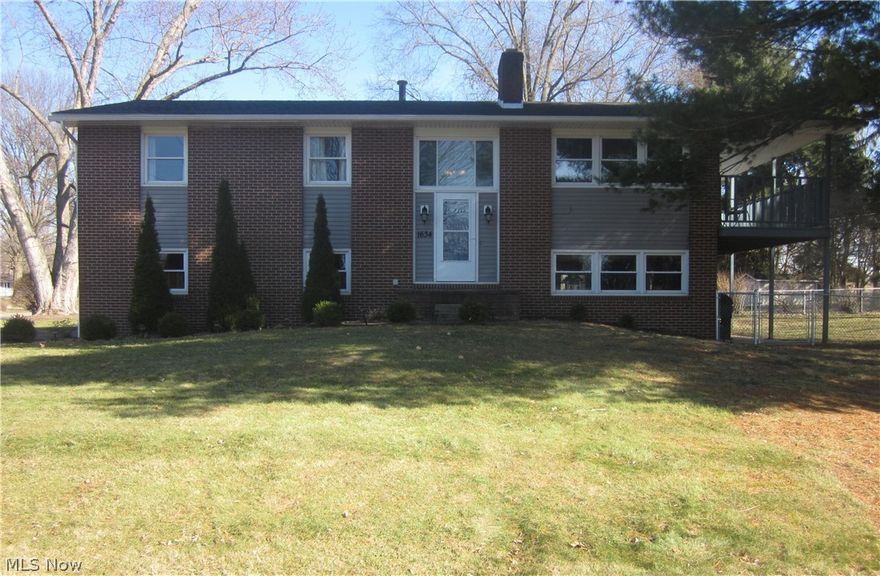 This inviting home is filled with natural light, with an abundance of windows and sliding glass doors bringing in sunshine through the day. Situated on a desirable, spacious corner lot, it offers timeless curb appeal with mature trees, clean landscaping, and an elevated front entry that makes a statement.  Step inside to a welcoming foyer with coat closet and leads up into a bright, eat-in kitchen with new stainless-steel appliances. A spacious living room offers a cozy wood-burning fireplace and a large sliding glass door that opens to a deck overlooking the fenced-in yard-perfect for relaxing or entertaining guests. All bedrooms offer generous closets, including a primary suite with a private bath. The walkout lower level offers a bright, spacious family room with its own wood-burning fireplace and sliding glass door that opens to the patio. A conveniently located bathroom, combined utility/laundry room, and ample storage space. Bright, airy, and move-in ready-your next chapter starts here.