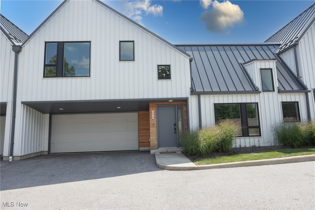 Discover refined contemporary living in this lightly lived-in, three-year-old townhome, perfectly positioned in Beachwood’s coveted 24 Hundred community—celebrated for its award-winning schools and unbeatable location. A rare find, this residence blends bold architectural style with the ease of low-maintenance luxury. The exterior’s sleek metal siding delivers modern curb appeal with zero upkeep. Inside, a sophisticated neutral palette, soaring ceilings, rich hardwood floors, and expansive windows set the tone for a bright, open-concept main level. The inviting living area flows effortlessly into a dining space and an impressive designer kitchen featuring quartz countertops, premium stainless-steel appliances, an oversized island with breakfast bar, pantry, and a reverse osmosis drinking water system. Step through sliding doors to the first of two private patios—perfect for entertaining or al fresco dining. The main level also hosts a luxurious primary suite with a large walk-in closet and spa-style bath boasting dual vanities and a custom step-in shower. French doors lead to a secluded patio, an ideal retreat for morning coffee or evening relaxation. Additional first-floor conveniences include a stylish powder room, a functional mudroom, a dedicated laundry room, and interior access to a spacious two-car attached garage. Upstairs, a versatile loft offers space for a home office, reading nook, or media lounge and opens onto a private balcony. Two generously sized bedrooms, a full bath, and a linen closet complete the second level. Situated just minutes from Beachwood Place Mall, Legacy Village, Pinecrest, fine dining, shopping, the library, parks, and major highways, this home also offers exclusive community amenities, including the Beachwood Aquatic Center, tennis courts, and playgrounds. A home warranty is included for added peace of mind. Enjoy the perfect blend of style, convenience, and premier Beachwood living in this exceptional townhome.