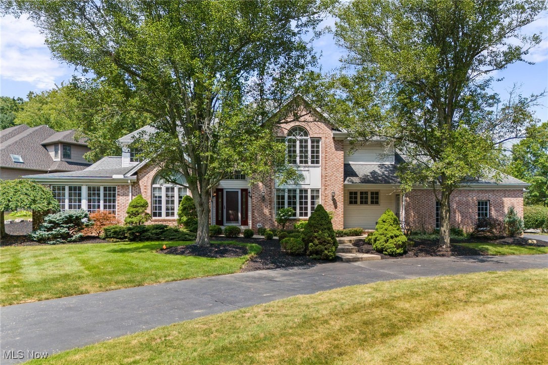 Discover a home where elegance meets everyday comfort. From the very first glance, the striking curb appeal hints at the exceptional spaces within. Step through the welcoming foyer into a sun-drenched living room, where a skylight, cozy wood-burning brick fireplace, and wet bar—with direct access to the back deck—create the perfect setting for hosting friends and family. Entertain in style in the sophisticated dining room, showcasing a vaulted ceiling and sparkling chandelier, or relax in the adjoining family room, flooded with natural light. The chef’s kitchen is a culinary masterpiece, featuring rich wood cabinetry, a center island with cooktop and sink, granite countertops, a ceramic tile backsplash, and stainless steel appliances—all included. A charming breakfast nook with large windows overlooking the yard makes the ideal spot for morning coffee. First-floor living is effortless with the spacious primary suite, offering generous closet space and a spa-like bath with a double vanity, soaking tub, and walk-in shower. A bright home office, laundry room, and half bath complete this level. Upstairs, discover a second expansive owner’s suite, along with two additional airy bedrooms—one featuring a bonus room perfect for a sitting area or second office. A full bath with a double-sink vanity and tub/shower combo completes the upper level. The fully finished lower level is an entertainer’s dream, with a built-in entertainment center and gas fireplace, a wine display, a bar area, and a convenient half bath—perfect for movie nights or game days. Outdoors, enjoy the tranquil, park-like setting with a covered deck, patio area, and wooded backdrop that ensures privacy. An attached three-car garage rounds out this exceptional property. Great location close to parks, golf club, shopping and local restaurants. Seller is offering a one-year America’s Preferred Home Warranty. Experience the perfect blend of comfort, luxury, and sophistication—schedule your private showing today!