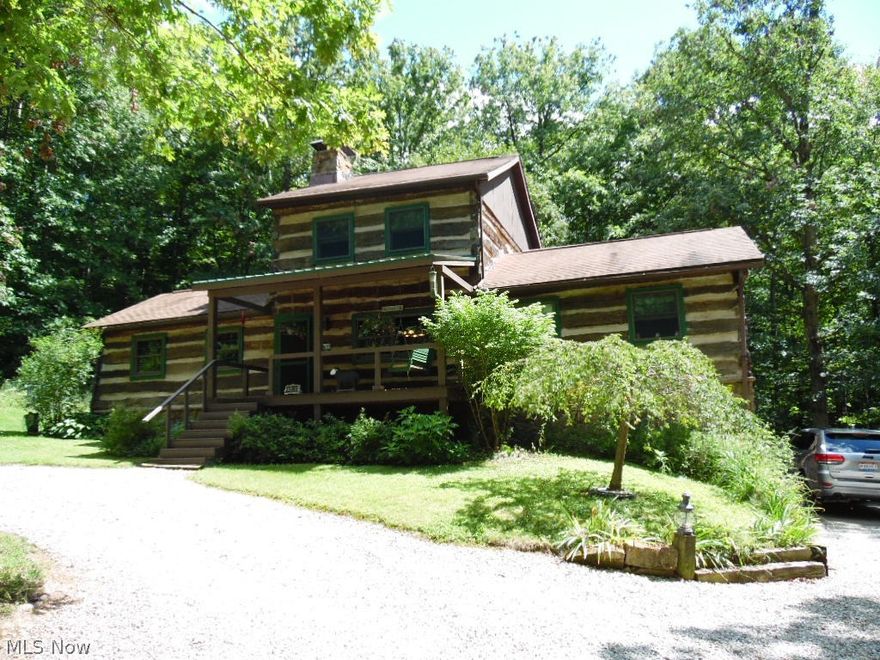 Paradise in the woods. A unique, rustic, log cabin on just over 15 acres. Two bedrooms, 2 full baths, an open fireplace between the kitchen and L.R with gas logs.
A full, walk-out basement with poured walls. Covered front porch, screened-in back porch with a deck off of it. Newer balcony off the master bedroom over looking beautiful landscaping and a garden pond. Has a stand-by generator. A storage shed.