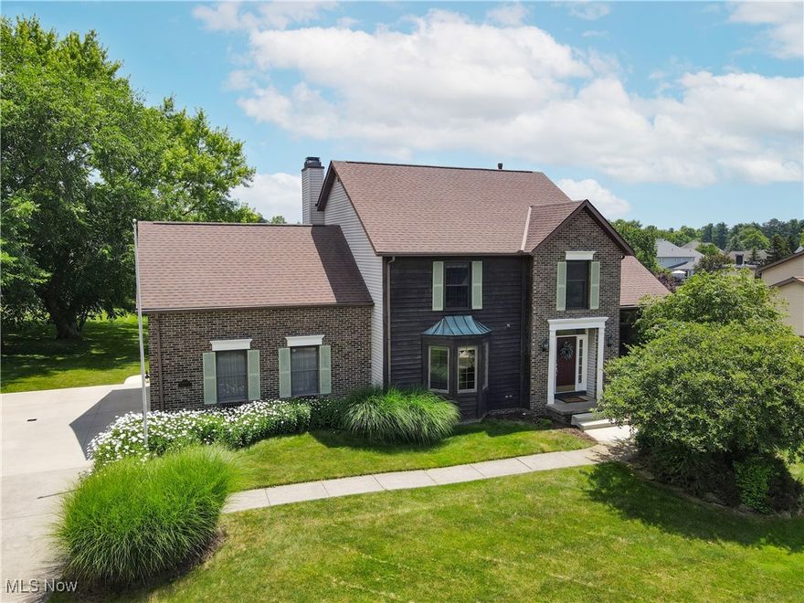 Welcome Home!  This property is located in a vibrant and well-maintained community.  Step into an inviting, open foyer that flows into the living room, which offers elegant crown molding and connects to the dining room, featuring an abundance of light from  the transom windows.  The spacious eat-in kitchen, complete with a large pantry, appliances, and partial granite countertops offers plenty of cabinet and counter space. The kitchen opens to the family room featuring a gas-start, woodburning fireplace and glass door leading to a beautiful patio—perfect for outdoor entertaining, grilling and relaxing.  Enjoy soaring ceilings throughout the home!   French doors open to a private office with bay window —ideal for working from home. A stylish, updated powder room with granite countertops and a well-appointed mudroom with laundry hookups, sink, granite surface, and ample storage complete the main floor.  Upstairs, you'll find a spacious, primary suite with a 11' x 6' walk-in closet and an ensuite bathroom featuring dual vanities with nice storage, a jetted soaking tub, walk-in shower, and private water closet. Three additional generously sized bedrooms could also be used as extra home offices.   The finished walk-out lower level offers incredible versatility—perfect for a game room, home gym, recreation area, and even a bar space - whatever fits your needs. A large storage room with laundry area adds to the functionality of this home.  Recent Updates Include:  Granite counters in kitchen, two bathrooms, and mudroom; new sinks; and side garage man door (2022); Concrete driveway (2 car width), back patio, front steps, and sidewalk (2021); New insulated garage door - 2018; Updated, finished basement and some windows replaced (2016); Furnace and AC replacement (2013); Roof - 2011.  This beautifully maintained property offers living and entertainment space, style, and plenty of storage —ready for you to move in and make it your own.