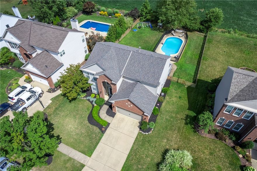 Welcome to this stunning colonial in the highly desired Highland Park Community. This inviting home is ready for you to call your own! Enter into the 2-story foyer with updated lighting and beautiful hardwood floors that flow through the updated formal dining room and into the spacious eat-in kitchen.  The kitchen features granite countertops, a center island, ample cabinet space, and a pantry. Sliding doors lead to the stunning deck, fenced yard, and a lovely view complete with a fantastic in-ground pool! The kitchen opens to a spacious family room with a gas fireplace, ideal for entertaining or cozy evenings. A convenient half bath and laundry room complete the main level. Upstairs, the primary bedroom offers a vaulted ceiling, a dream walk-in closet, and a beautifully renovated en-suite bath with a double sink vanity, soaking tub, walk-in shower, and stunning tile. Three additional large bedrooms and a full bath provide plenty of space for family and guests. The finished basement is a versatile space, perfect for a recreation area, including a gas fireplace, and offering plenty of options for entertaining, workouts, or a playroom. Additionally, the basement now features a beautiful added half bath for convenience. Outside, the deck spans the width of the home, ideal for summer BBQs or watching family and friends swim in the in-ground pool or enjoy the included playset. A pool fence was added in 2022. The large private yard is perfect fit for your needs. Many updates including a new roof (2022) and HVAC (2023), sump pump (2022), primary bath and closet remodel (2023), basement half bath (2022), and fresh paint throughout. Located in tranquil, desirable Avon, Highland Park subdivision features a community pool, tennis court, and playground. With easy access to I-90 and close to Avon Commons, this home is a must-see! Come see this beauty today and make it your own!