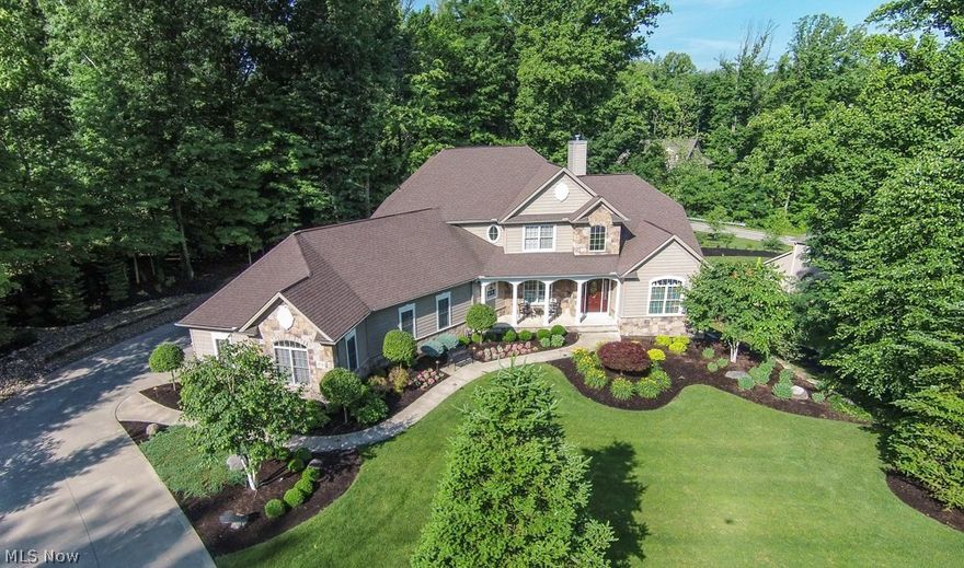 This home is an absolute gem and is loaded w upgrades from top to bottom. Only the finest finishes have been used in this custom designed home. The home is nestled on 1 acre in the Noble Ridge Sub. Division. Home is loaded with lots of windows throughout for plenty of natural light. First floor master bedroom with gorgeous glamour bath. Stunning office with french doors and tile floor. Beautiful great room with 2 story soraing ceilings, skylights and a showcase fireplace. A designer dream kitchen (28x24) features huge granite breakfast bar, warm wood floors and top of the line appliances package. Additional living suite with complete kitchen, family room with fireplace, possible 6th bedroom with full bath, rec room, exercise room, workshop, storage, and walkout slider to patio. 4 bedrooms with bonus room/kids play room or computer area. Check out the garage too. So much more! When only "the best" will do.