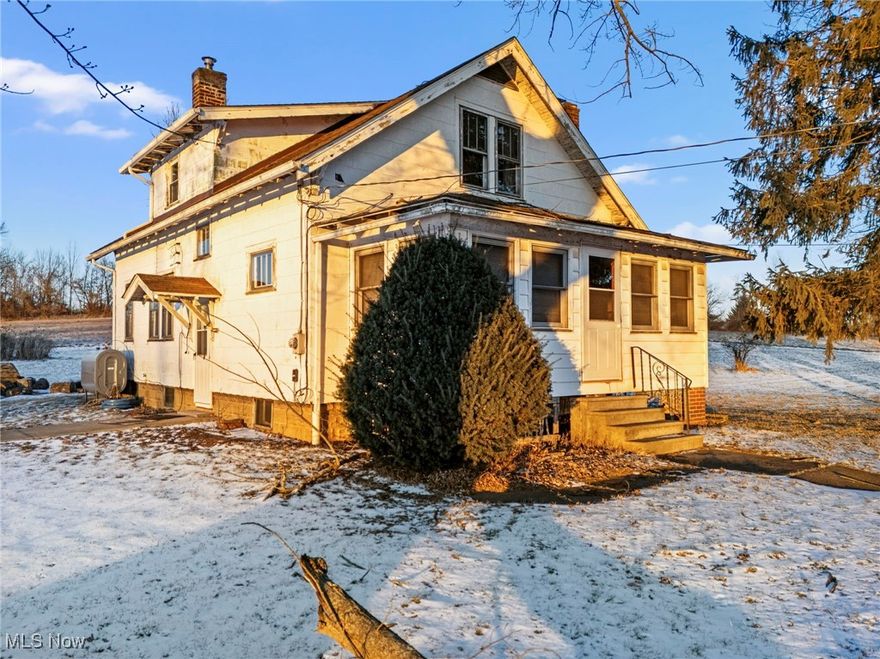 Located on an extra large lot with acreage, 10595 Forty Corners offers a rare opportunity for buyers looking for space, functionality, and long term potential. This 3 bedroom, 1 bathroom home features original hardwood flooring, a spacious kitchen, and a three season front porch that adds additional living space and a welcoming entry to the home. The property will require TLC and is ideal for buyers ready to renovate and build equity.

Outside is where this property truly stands out. A large, newer garage outbuilding with tall ceilings and double garage doors provides excellent space for vehicles, equipment, or workshop use. Additional outbuildings include a horse barn and chicken coop, both in need of repair but offering great potential for hobby farming or storage.

The home is serviced by propane heat, a private well, and a septic system, with both the septic and furnace being newer major improvements. With generous acreage, multiple outbuildings, and room to grow, this property presents a unique opportunity for buyers seeking land, flexibility, and future potential.