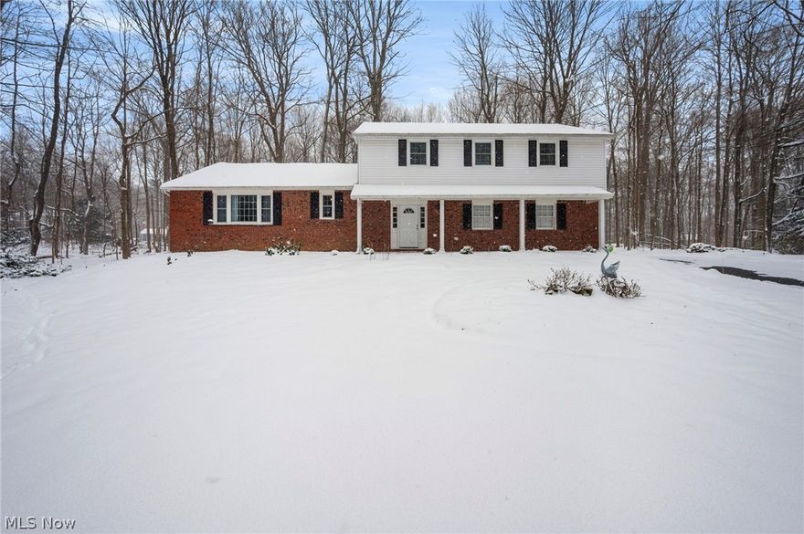 Set on 1.61 wooded acres in Bainbridge's sought-after Pilgrim Village, this beautifully updated Colonial offers space, privacy, & access to exceptional community amenities. Located in the Kenston School District & situated on one of the larger lots in the neighborhood, the property provides a serene setting surrounded by mature trees while remaining part of a vibrant lake community whose residents enjoy access to Lake Taylor, w/ a sandy beach, swimming, fishing, kayaking, paddleboarding, volleyball, BBQ area & a covered pavilion. With 2,400 sq ft, 4 bedrooms & 2.5 baths, the home features flexible living spaces designed for everyday comfort & entertaining. An updated eat-in kitchen features quartz countertops, stainless steel appliances & a dinette area. A family room w/ brick fireplace & access to a back patio & expansive backyard creates easy indoor-outdoor flow. A welcoming living room w/ a large picture window opens to a formal dining room w/ built-in cabinetry, and a spacious 1st-floor laundry & mud room and attached 2-car garage add convenience & functionality. The primary suite includes an en-suite bath w/ a walk-in shower, and 3 additional bedrooms plus a versatile bonus room provide options for a home office, playroom, or additional lounge space. A partial basement offers excellent storage & potential for future finishing.  Recent updates include: Replaced boiler (2025), washer/dryer (2023), installed buffet cabinets in dining room (2025), gutter guards (2025), replaced rear 2nd story gutters, sub-fascia & added larger soffits (2025), added fiberglass insulation batts in attic (2025), removed 7 large trees close to house (2024), painted master bed/bathroom & guest bedroom (2024), and more! INCLUDED are ALL kitchen appliances, washer/dryer, window A/C units, Ring doorbell, TV mounts, and all window treatments. Conveniently located near US-422, OH 306, shopping, restaurants, schools, parks, and other local attractions. A must see!