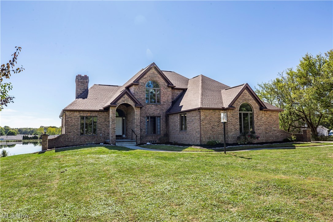 Set far off the road and overlooking your own 4-acre stocked pond, this brick residence on 11 scenic acres in Wadsworth City & Schools delivers the hard-to-find combo of privacy, water, and serious outbuilding capacity—garage space for up to 8 vehicles, including a heated 3-car attached garage with EV chargers plus a detached, temperature-controlled garage (formerly a gym) for workshop, toys, or oversized vehicles. Inside, a first-floor owner’s suite features a soaking tub, walk-in shower, and double vanity; upstairs, three oversized bedrooms offer new carpet and direct bath access (one ensuite; two via Jack-and-Jill). The main level blends polish and function with a formal dining room and front office—both with hardwoods, crown molding, and a dual-sided fireplace—while the living room showcases custom built-ins and sweeping pond views. The updated kitchen brings granite, new stainless appliances, a walk-in pantry, and a sunny breakfast nook. Outdoor living is easy from the raised back deck for morning coffee and wildlife watching, or the light-filled, finished walk-out lower level designed for entertaining, complete with a secure walk-in safe and patio at the water’s edge. Major updates—new roof, furnace, tankless hot water, and solar—add peace of mind. Offered as two buildable parcels, this is a rare acreage opportunity with modern comforts and flexible spaces already in place. Properties with private ponds, abundant wildlife, and this level of garage/outbuilding utility seldom hit the market—do not miss this opportunity!