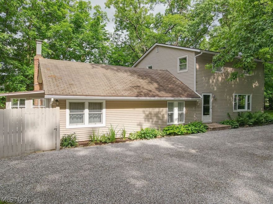 If you've been looking for country living without the drive, this 4-bedroom colonial in Stow will be perfect, offering solutions to many things you've held out for. Located on a 1.6 acre lot, the home boasts a fantastic floor plan and will provide comfort and ample space for all your needs, both inside and outside. Over time, the home has been expertly-remodeled. You'll be delighted when you see the expansive 27 foot living room with stone fireplace and hardwood flooring. It's set up nicely for a long dining table at one end, and is large enough for numerous seating arrangements for company. The kitchen has been updated with maple cabinetry and comes with appliances. There's even a lovely eating area nearby. If you have a need for multi-generational living, the original, single-story part of the home is now a first-floor suite, featuring a sitting room, a bedroom, it has direct access to a full bath, laundry room, the kitchen ... and it has its own entrance! It could be a game-changer for families who have someone who desires to be on the main floor. A major 1595 sq ft. addition came in 1978, adding 3 addt'l bedrooms, full bath with double lav, lots of storage and a finished flex space that could be a game room, play room or could easily double as a home office. Ready to add a puppy to your family? The yard has a huge fenced-in side and back yard with a park-like feel, and will be great for hosting all kinds of events with family and friends. Lots of improvements over time, including kitchen and bath remodels, first floor laundry, HVAC and more. Bring a work vehicle home? You'll appreciate all of the parking possibilities the property has to offer. The driveway goes back 275 ft! You'll love the area, too. The Hudson library and shopping is just north, you're minutes to highway access, under 15 minutes to KSU and you're right in the middle of the Cuyahoga Valley National Park region, close to the Norton Bike and Hike Trail. You won't want to let this one pass you by!