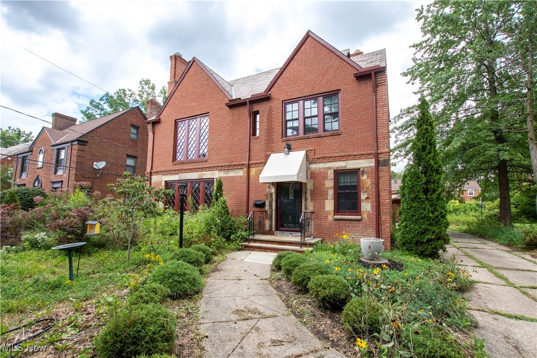 Quality-built and beautifully updated home in the historic Ludlow neighborhood! This 1940s brick home perfectly blends original character with modern updates, just one block from the newly built Ludlow School and walkable to parks, Shaker Square, library, grocery, shopping, and rapid transit. The sun-filled main floor features a formal living room with a cozy gas fireplace and replacement architectural casement windows that retain the classic Tudor harlequin mullion design. The dining room opens to a covered patio and backyard, ideal for entertaining. The updated eat-in kitchen showcases designer-selected cabinets, stainless steel appliances, quartz countertops, and new flooring, while the den/office provides a private work-from-home space. A convenient half bath completes the main level. Upstairs, two bedrooms share a Jack-and-Jill full bath, and a third bedroom includes access to the rear rooftop balcony, with a second full bath off the hall. The finished third floor offers a fourth bedroom and a third full bath, adding over 400 sq. ft. of flexible living space. Home improvements include $15,000–$20,000 in landscaping, with $10,000 invested in the front yard featuring trees, shrubs, birch trees, wildflowers, Japanese maple trees, bird baths, lanterns, and new awnings—making this home a certified wildlife habitat! Additional updates include central air, refinished quarter-sawn oak floors, Anderson replacement windows, updated 200 amp electrical service, replacement gutters, downspouts, and fascia. The fenced yard provides privacy and space for outdoor enjoyment. This Ludlow gem offers the perfect combination of historic charm, modern comfort, and thoughtful upgrades—ready for you to move in and enjoy!