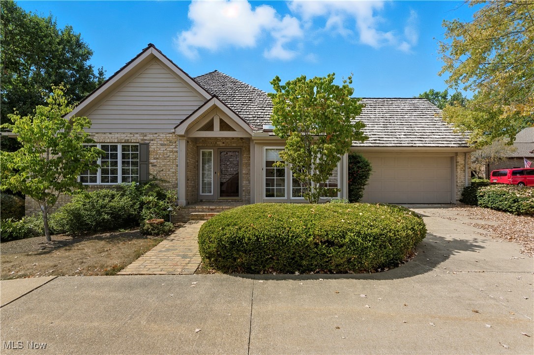 This one-owner condo is tucked away in the gated community of Auburn Knolls and combines natural light, thoughtful design, and surprising space. The bright eat-in kitchen stands out with granite countertops, skylights, and pull-out cabinetry. A mudroom connects to the attached two-car garage—complete with drain, electricity, and hot/cold water—and provides plenty of built-in storage along with the convenience of first-floor laundry. The vaulted great room is filled with warmth, showcasing hardwood floors, custom built-ins with a gas fireplace, and doors to a private deck with wooded views. The primary suite feels like a true retreat, with soaring ceilings, skylights, dual walk-in closets with custom shelving, and elegant built-in cabinetry. The spa-inspired bath offers a tiled walk-in shower, oversized double vanity, jetted tub, and abundant storage. A stylish half bath and a main-level bedroom with built-ins (perfect for an office or guest room) complete the first floor living space. The finished lower level is a welcome surprise, with a rec room, bedroom with dual closets, and a full bath—ideal for guests, hobbies, or whatever buyer desires. A large unfinished area area provides even more space and storage. Seller providing one year home warranty for buyer's peace of mind! Don't miss your chance to enjoy condo living at its finest and make this beautiful and timeless Auburn Knolls condo the next place you call "home".