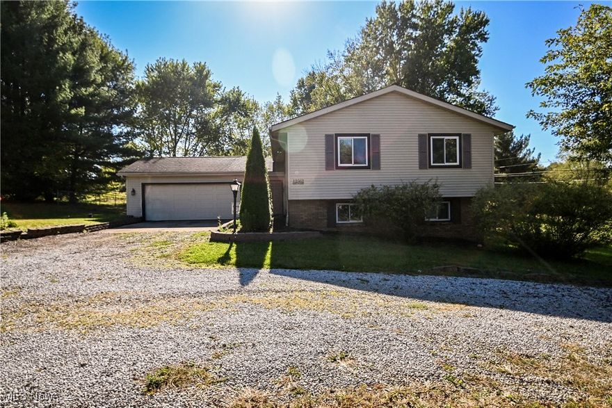 Welcome home to 12562 Weygandt St NW; located in the peaceful country setting of Canal Fulton with easy access to 21! This spacious bi-level home offers over 2400 square feet of living space, and sits on over half an acre, giving you plenty of room to spread out both inside and out. On the upper level you'll find the living room, kitchen (with a large pantry), dinning room, primary suite complete with a full bath and a large walk-in closet, and a second bedroom with attached full bath. On the lower level you'll find the family room with a wood burning fireplace, French doors leading out to the yard, two additional bedrooms, a third full bath, and a large office (or fifth bedroom). Enjoy the beautiful weather on the expansive two-tiered deck overlooking the fully fenced in yard, and the cooler days curled up in front of fireplace. Seller is offering a $3,000 flooring concession. Updates include; new furnace ('22), roof ('18), primary bath shower replaced ('22), water pressure tank ('21), dishwasher ('23). Call your favorite agent for a private showing!