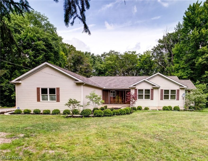 Discover this country hideaway on over 13 picturesque acres, with Bates Creek running through your property.  This 3 RR 2.5 BA Ranch home built in 2008 has so much to offer.  Open floor plan with beautiful oak hardwood flooring throughout and fine wood work and trim.  Great room with vaulted ceilings and wood beam makes it a great space.  Dining area and kitchen make a great place to entertain family and friends.  Large island with a solid wood top, stainless steel appliances, a culinary enthusiast will be delighted.  The master bedroom features hardwood floors, walk-in cedar closet, sliding glass door that leads to backyard, a master bathroom with ceramic tile and double sinks.  This ranch home also boasts a large laundry room, mudroom, extra-large two and a half car garage with its own heating system, and a full partially finished basement with maple hardwood and roughed in for a full bath.  The home has a second heating source in a wood burning boiler system and a large outbuilding