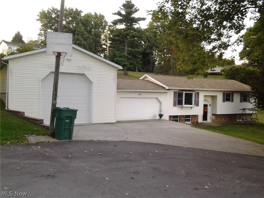Don't miss out on this split foyer home with 2 bedrooms up and one on the lower level. A mans dream garage  24 w x 30 L x 14 H with 12 x 12 door plus a 2 car garage attached to the house. Radiant heated floors in big garage with center drain. New shingles on home and garage in 2014. Remodeled kitchen with a door leading out to a large back deck. Large family room in lower level with an extra room that could be a 3rd bedroom or an office. New leased hot water tank. Sits at the end of the cul de sac. Public water available