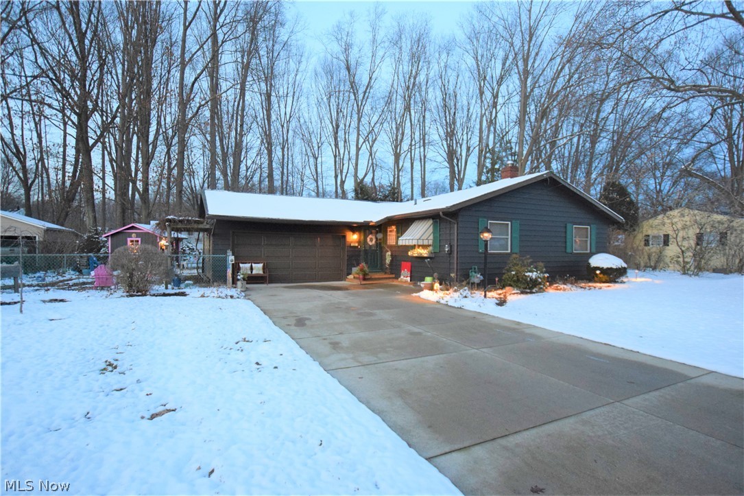Three bedroom, two bathroom ranch in Munroe Falls with two-car attached garage! Eat-in kitchen has updated laminate wood flooring, white cabinets, and gorgeous countertops. New vintage-style stove, fridge and dishwasher -- super cute and unique! Living room is spacious with hardwood floors and a wood burning stove. Large sunroom off the living room leading to a covered patio. Bedrooms have hardwood floors. Beautifully landscaped with blueberry bushes, currant bushes, and rhubarb! Covered outside patio with grill! Back yard also has a new privacy fence along one side and storage shed. The 4 seasons room boasts a new heater and air conditioner unit. Lots of updates on this one, move in ready! No worries as this also comes with America's Preferred Home Warranty.