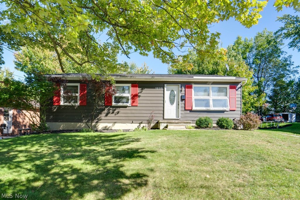 Did you say 3 bedroom RANCH in North Hill? Welcome to 1239 Big Falls Ave. Akron, OH. This home is move-in ready and available now! You'll appreciate the Private, Fenced-in, and flat back yard with a patio. Plenty of room to entertain outside, build a play set, plant a garden, or design an outdoor lounge! Enjoy the updated eat-in kitchen with newer cabinets. Appliances (Dishwasher, Stove, Microwave, Fridge) all stay and are a part of the one year APHW Home Warranty (included with the sale). There are 2 FULL Bathrooms, plus a partially finished basement! The basement could easily be finished to offer additional living space. Updates include Bathrooms, Kitchen, and Roof. Separate Laundry Room in the Basement - Washer and Dryer stay.