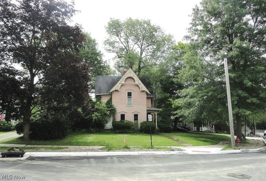 HISTORIC District of Chagrin Falls Village. This Home was built in 1875. Many of the carpentry details are Original. The garage is the original two floor barn that accesses the street below  The view from the back, is of the Chagrin River that flows throughout this Picturesque tucked away Village of Chagrin Falls. A piece of History, a piece of Americana within a short drive to the bustling life of the Cleveland City. The Home; a Blank, albeit frayed, piece of Canvas save for Craftsman details that could be preserved in the right artistic hands. A Great Investment Opportunity for the right visionary entrepreneur.