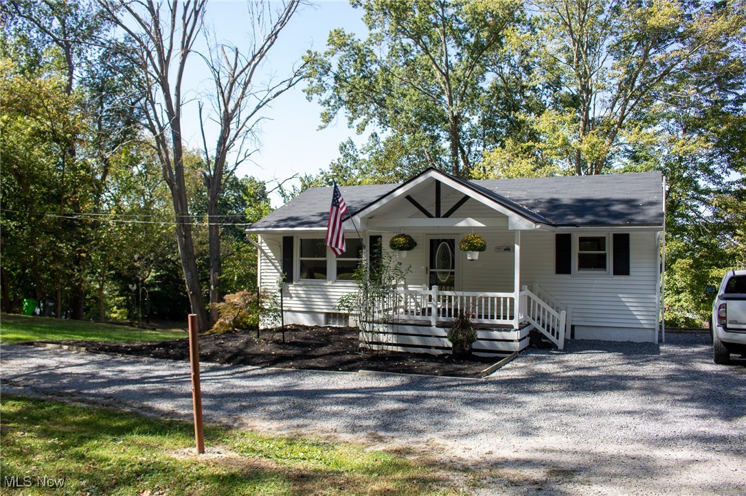 Charming and meticulously maintained 3-bedroom, 1½-bath home on .43 acres just outside the Coshocton city limits, offering a peaceful wooded setting and the perfect mix of country tranquility with convenient access to town. The property features a large outbuilding with a single garage bay and a workshop/storage area in the back, a chicken coop, and a cozy firepit area for outdoor gatherings. Recent roof shingles and numerous updates throughout provide modern comfort and peace of mind, and the interior shows exceptionally well — truly move-in ready. Ohio Basement Authority system installed basement system and excavation work has been completed to divert water drainage and provide better access to shed and parking. Contact me or your agent to schedule a private showing.