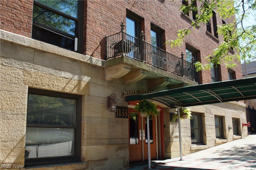 Work & play where you live!  This beautiful condo is located in the highly sought after Water Street Condo building, situated in the heart of the Warehouse District & just up the hill from the newly renovated East Bank of the Flats.  This building is exceptionally well maintained & carefully looked after.  This loft style condo is impeccably done & offers stunning hardwood floors, a remodeled kitchen w/ custom cabinetry, granite counters, stainless steel appliances & bar seating.  Ideal for entertaining, the kitchen opens up in to the great room, featuring high ceilings w/ original beams & exposed brick that carries in to the master bedroom, along w/ the hardwood floors.  The master bedroom offers easy access to the in suite laundry room and private bath, w/ beautiful vanity. The second bedroom & bath are the perfect space for a guest suite or office.  This building offers a 1st floor gym & rooftop deck w/ incredible views of the city & Lake Erie!  This home also has 4+ years of tax ab