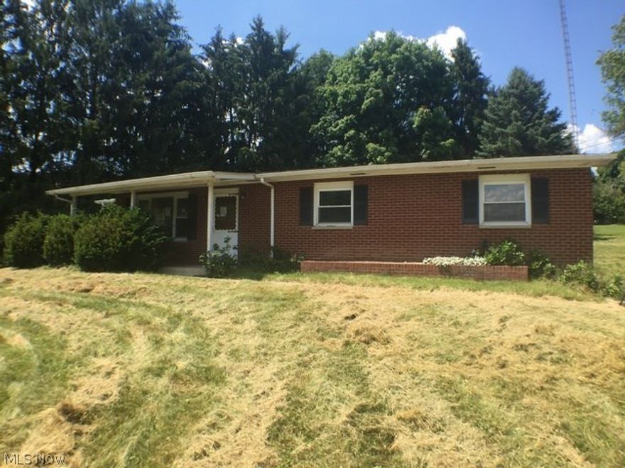 What a nice home. This brick ranch sits up on a rise with a nice view of valley in front of it.Loads of room, with a full basement, two car garage and an outbuilding. Gracing the interior are hardwood floors, kitchen and dining area.