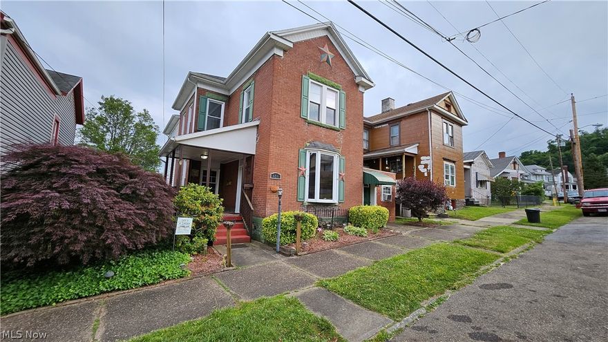 You're gonna love this one! Gorgeous, 4 bed 2 full bath, brick 2 story on Vine St, Martins Ferry, OH. The first floor of this beautifully updated, 2326 sq ft home features a huge, eat-in kitchen with custom island including chairs, PLUS a formal dining room, warm and welcoming living room with a gas fireplace and a giant bay window, first floor laundry room with too many cabinets to count and a spacious addition that includes a big bedroom and a full bathroom. This additional space also has it's own separate entry that would be perfect for guests, the college student home for breaks or an additional family/living room/playroom! Second floor boasts 3 bedrooms, and a dream bathroom complete with a fabulous, JETTED tub:) and extra large gorgeous vanity, and tons of storage throughout including a massive, walk-in closet in the master bedroom. And if you're wanting outdoor entertaining space, we've got that too! 19x12(approx) deck plus a covered patio below and a fenced in backyard plus the cozy, covered front porch with a side yard in between. There is additional parking in the back plus on street parking in front. Fully equipped with all major appliances, this well maintained home is truly MOVE-IN-READY. 2 gas furnaces plus a gas wall unit in basement, gas stove, gas water heater.  Addition has a rubber roof approx 8 years old, main house has shingles approx 25 years old,  newer windows throughout home, beautiful, solid wood interior doors throughout, recessed lighting and high ceilings. Call your favorite agent for more details and come see this in person! My photography doesn't do this gem justice:)
